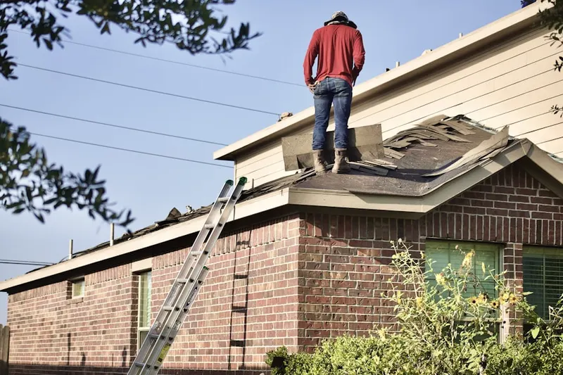 Professional roofer working on a residential roof in North Belle Isle
